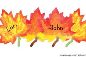 Watercolor painted autumn maple leaf place cards with names Lori and John in fall colors