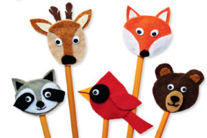 Five felt animal pencil toppers featuring a deer, fox, raccoon, cardinal, and bear