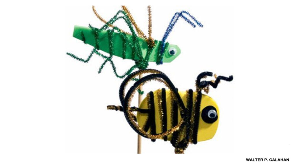 Giant pipe cleaner bug stick puppets including a yellow bee and green grasshopper