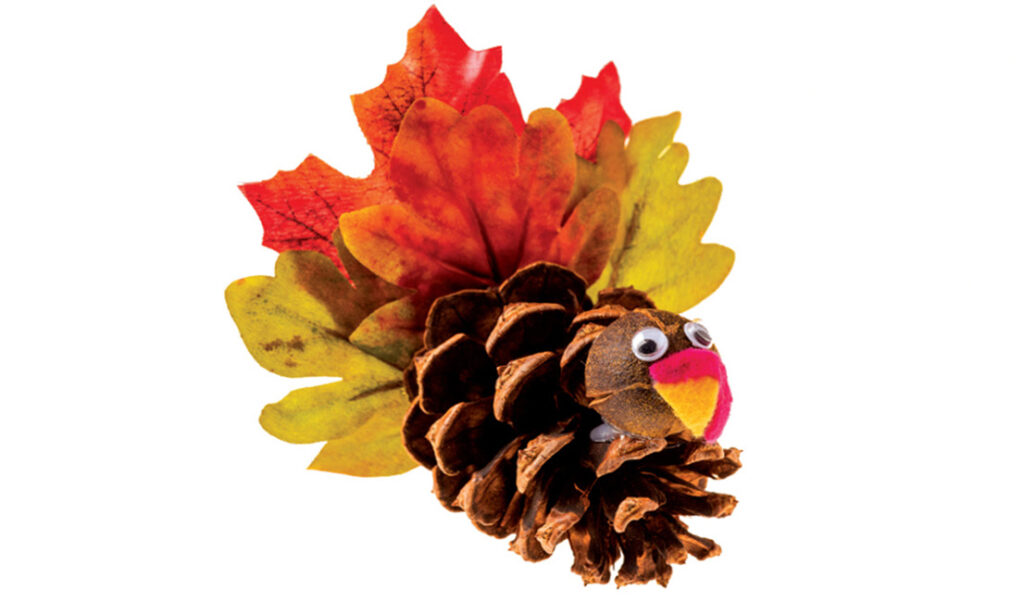 turkey made from a pine cone and colorful fall leaves