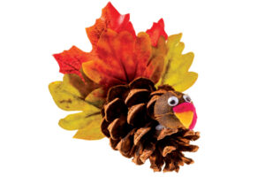 turkey made from a pine cone and colorful fall leaves