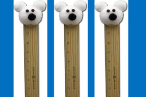 Three polar bear snow gauge crafts with cotton ball heads on wooden rulers on blue background