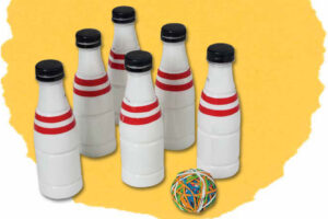 Six recycled plastic bottles painted as bowling pins with a rubber band ball