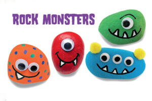 Four colorful painted rock monsters with googly eyes and toothy grins on white background