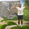 Image of young person dancing next to video screen of a goat climbing a mountain