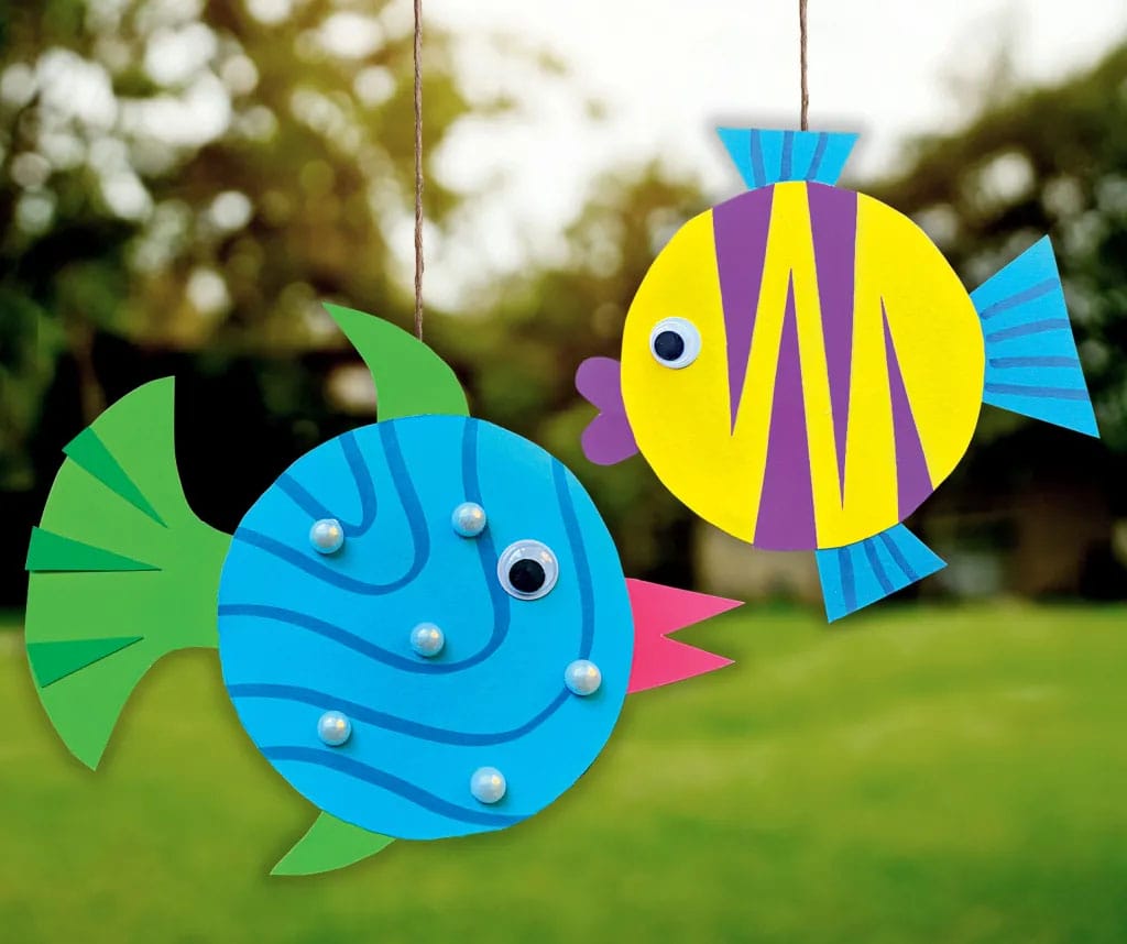 colorful fish craft made from jar lids and paper