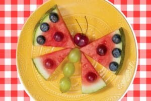 Butterfly made from watermelon wedge wings with grape body blueberries and cherry antennae