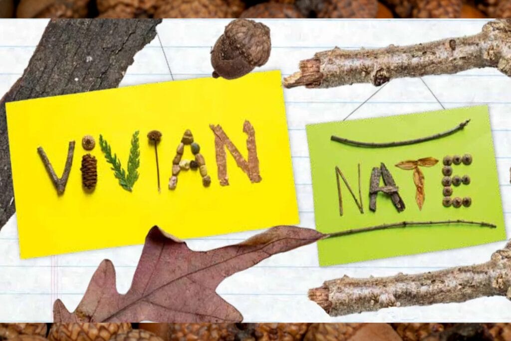 The names "Vivian" and "Nate" are spelled out with natural materials collected outdoors, including twigs, leaves, bark, pinecones, acorns, seeds, and small berries, arranged on colorful yellow and green paper cards. The cards rest on a notebook-style background surrounded by branches, bark, leaves, and other nature items.