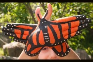 hands painted to look like a monarch butterfly